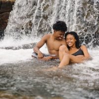happy couple sitting in the water