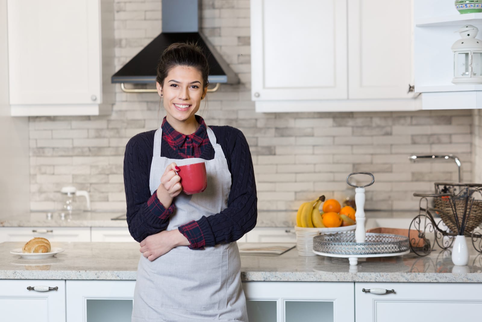 a black-haired woman drinks coffee