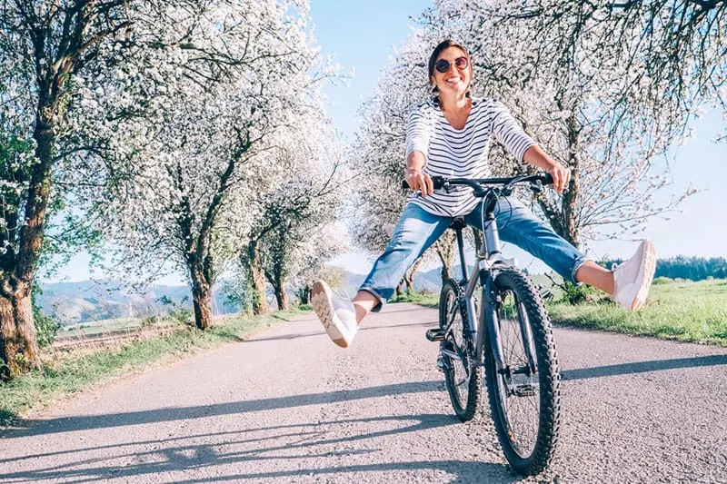 happy young woman riding a bike