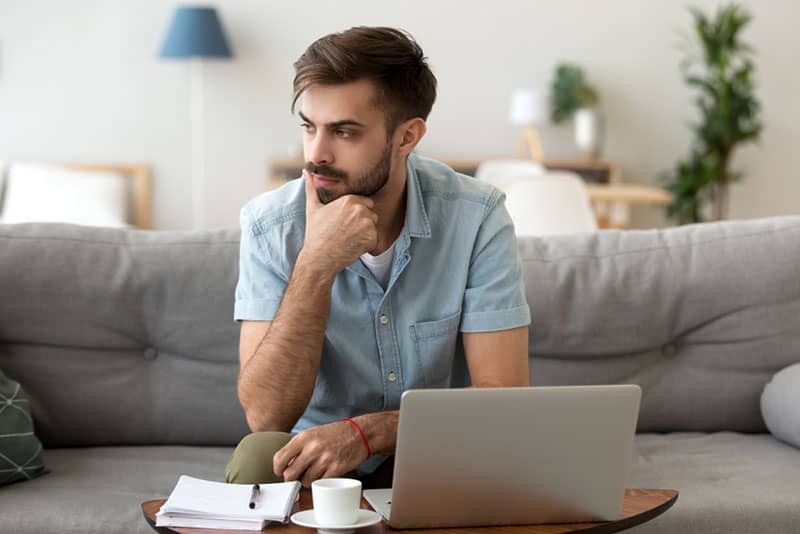 man look thoughtful in living room