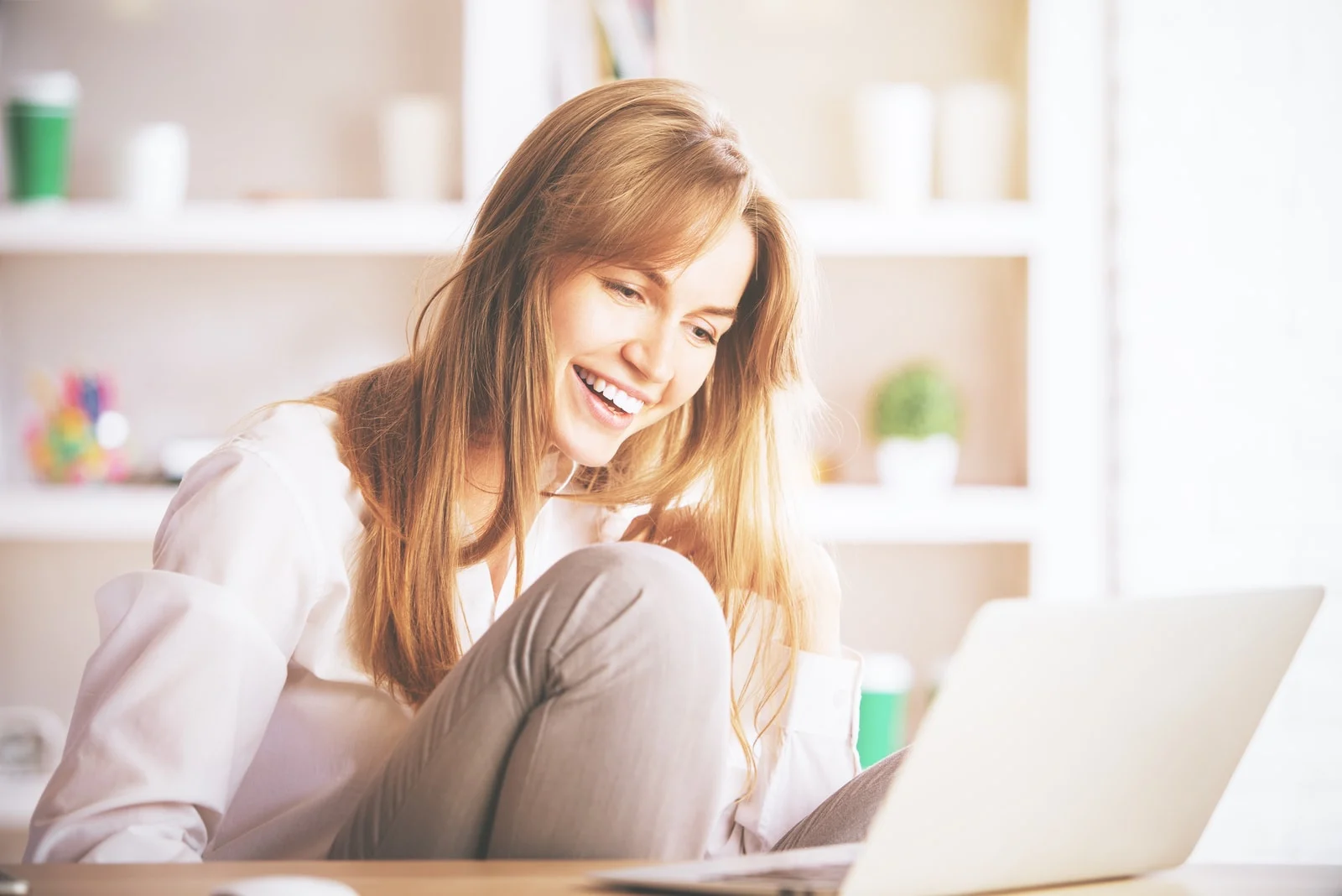 smiling young girl using laptop