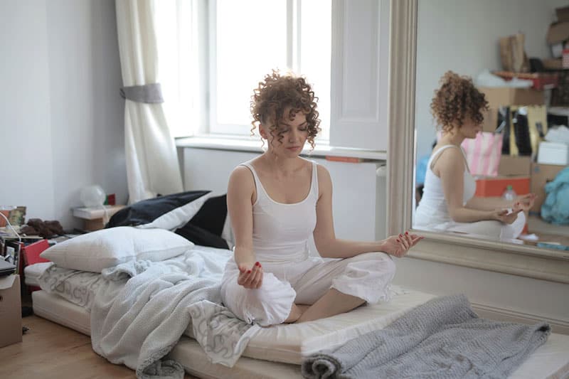 woman meditates in the room