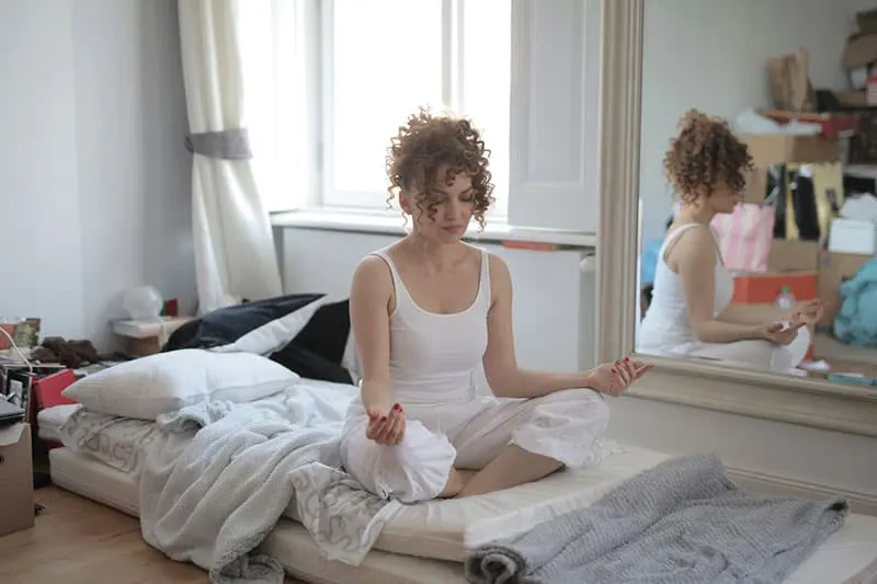 woman meditates in the room