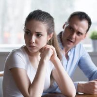 man yelling at sad woman