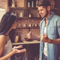 angry man yelling at woman in the kitchen