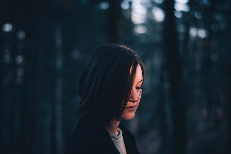 sad woman standing outdoor