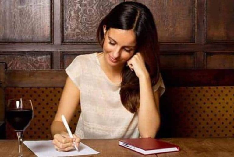 smiling woman writing a letter