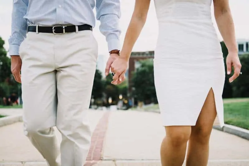 Man and woman holding hands outside