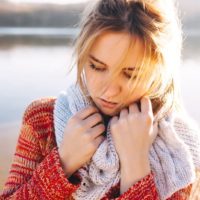 sad woman holding for scarf