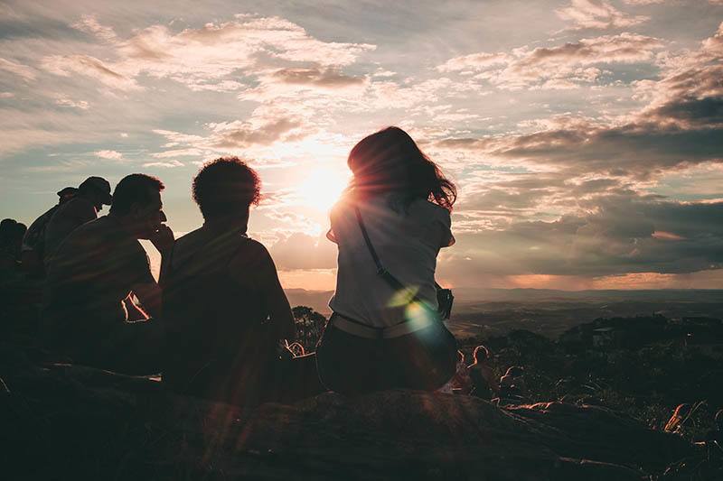 two people sitting on hill