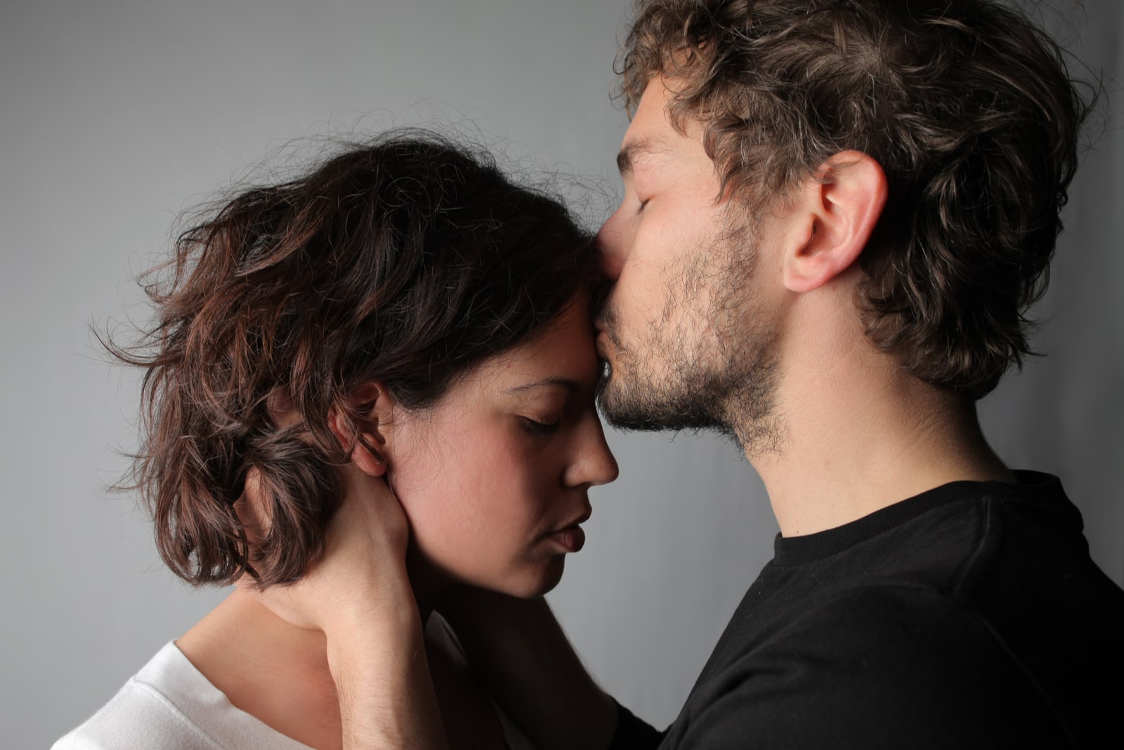 boyfriend comforts young woman