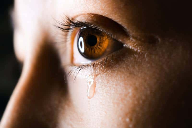 close-up photo of crying person with brown eyes