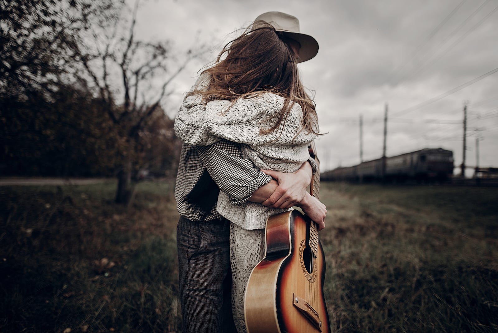 couple hugging in windy field