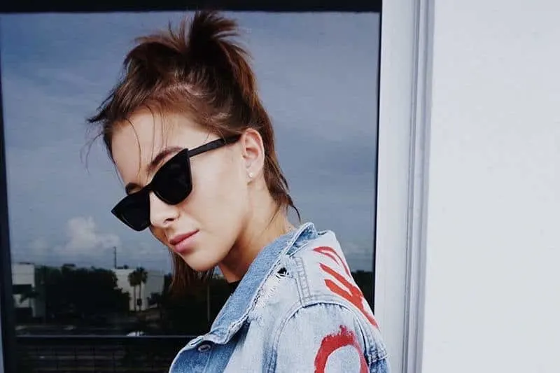 hipster woman wearing black sunglasses outside