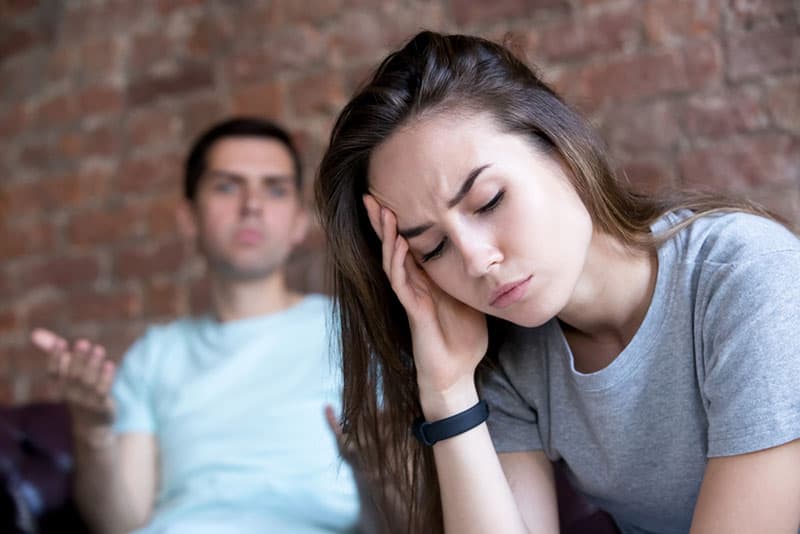 man arguing with worried woman