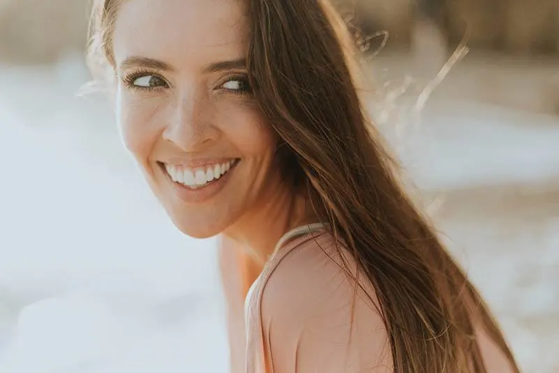 portrait of smiling woman outside