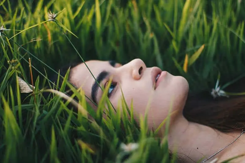 sad woman lying in the grass