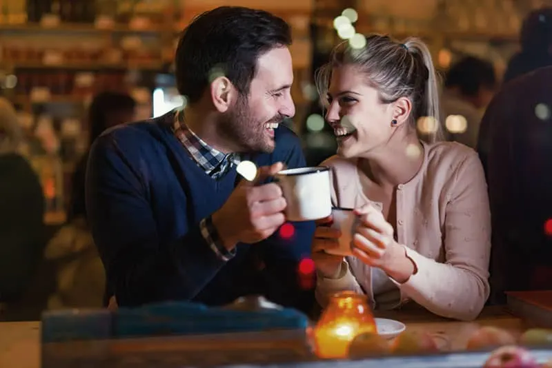 smiling couple on date at cafe