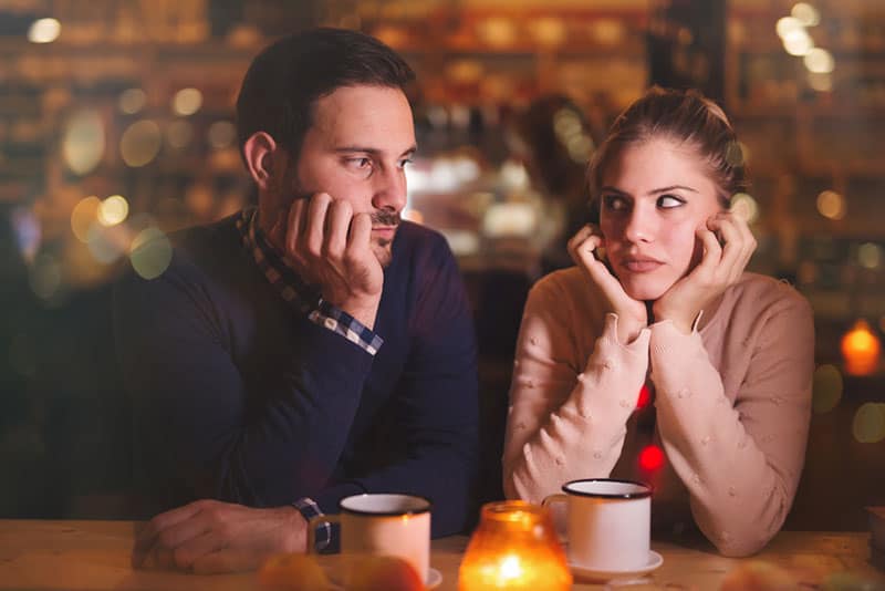 unhappy couple sitting in cafe