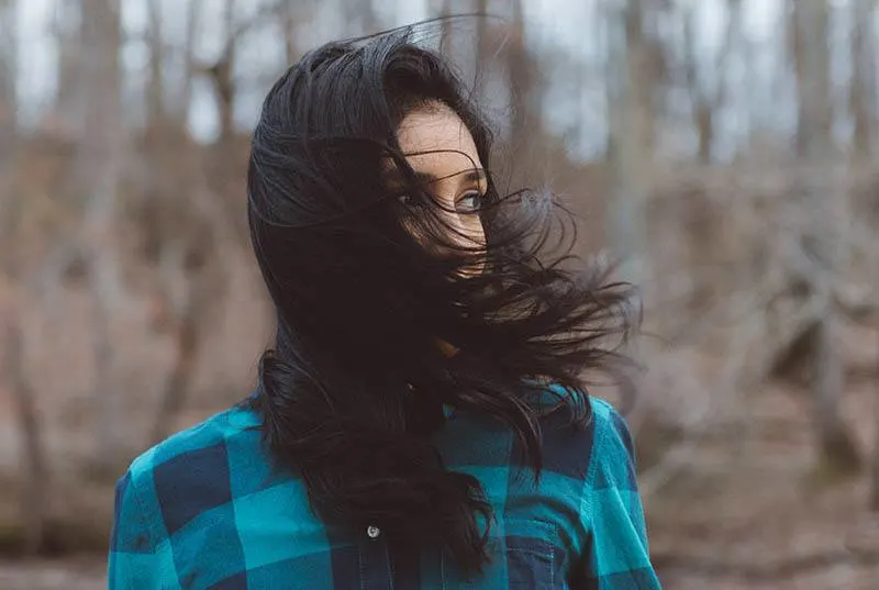 wind hair over woman face outside