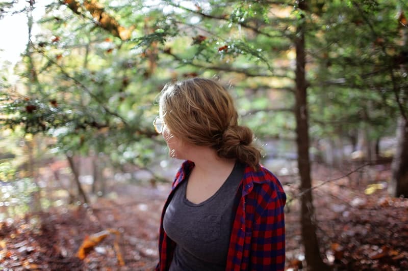 woman in grey shirt looking back