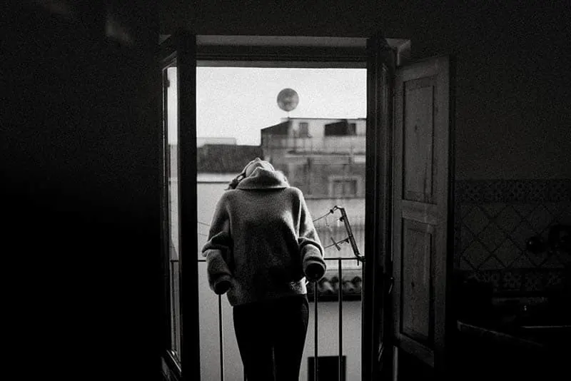 woman leaning on balcony fence