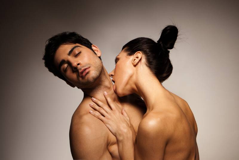 woman licking man's throat