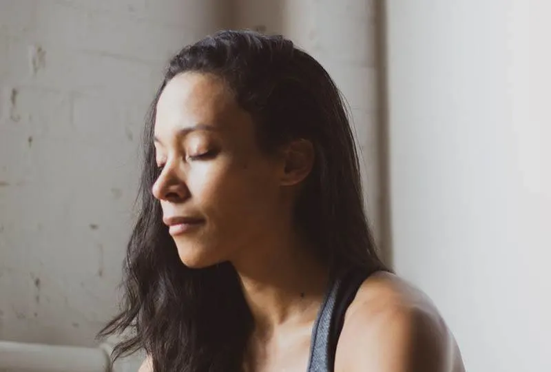 woman with closed eyes at home