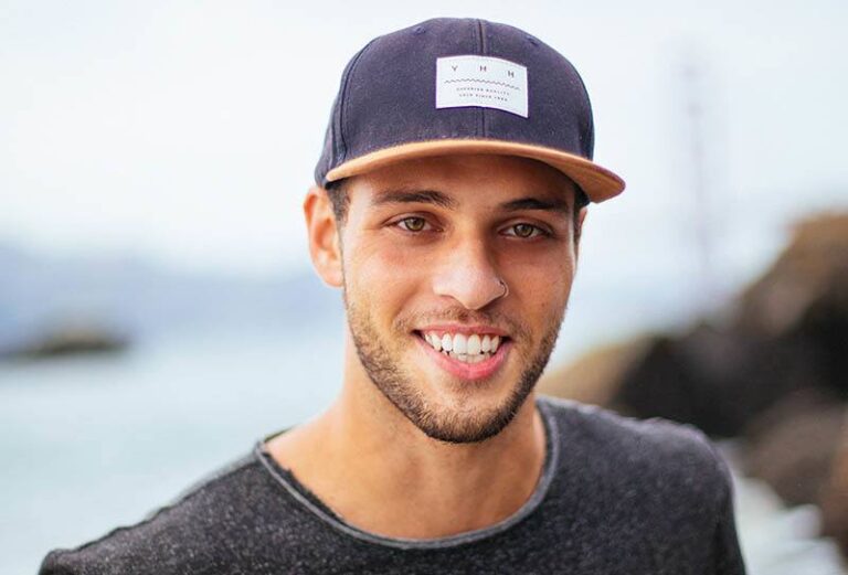 portrait of smiling man wearing hat outside