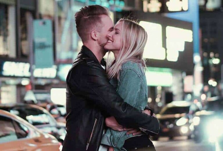 man kisses woman on cheek