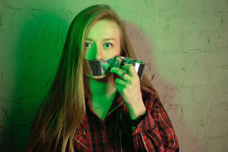 woman holding paper glue on mouth