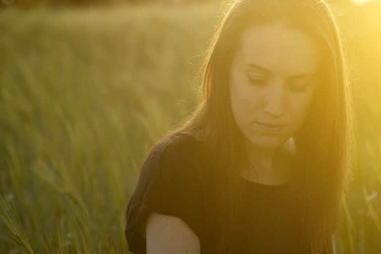 sad woman on grass field