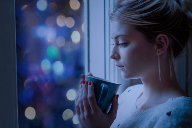 woman holding cup of tea