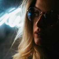 close up photo of blonde serious woman wearing sunglasses