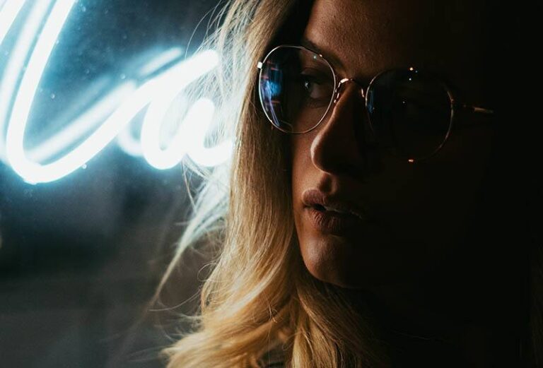 close up photo of blonde serious woman wearing sunglasses