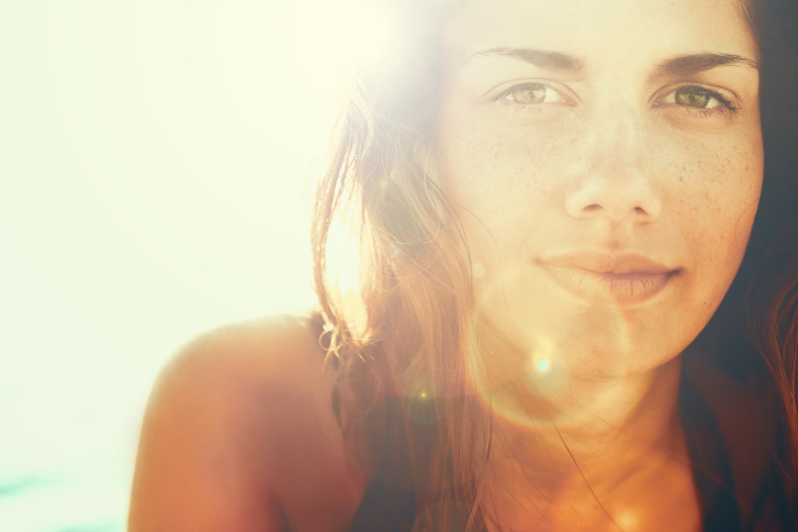 Face of young beautiful woman in summer sun