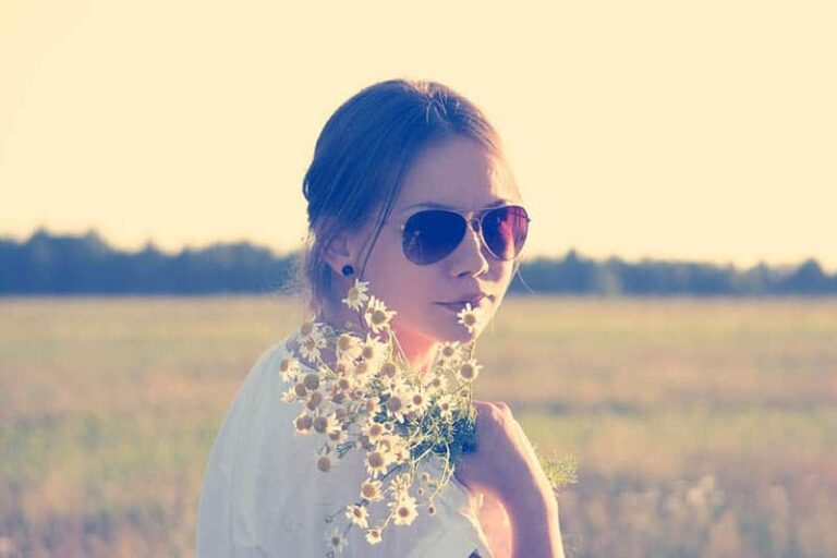 girl wearing sunglasses and flowers outside