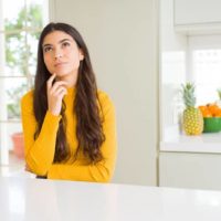 woman thinking in the kitchen