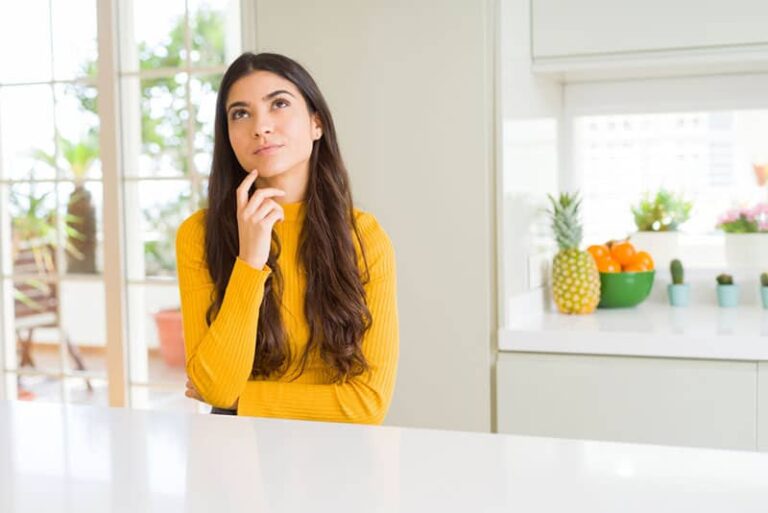 woman thinking in the kitchen