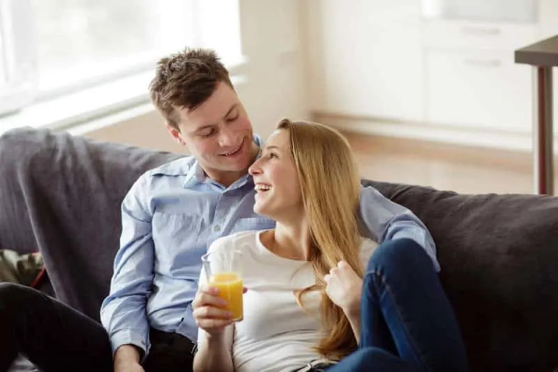Young man and woman relaxing and drinking the orange juice