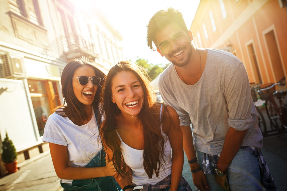 a group of smiling friends having fun on the street