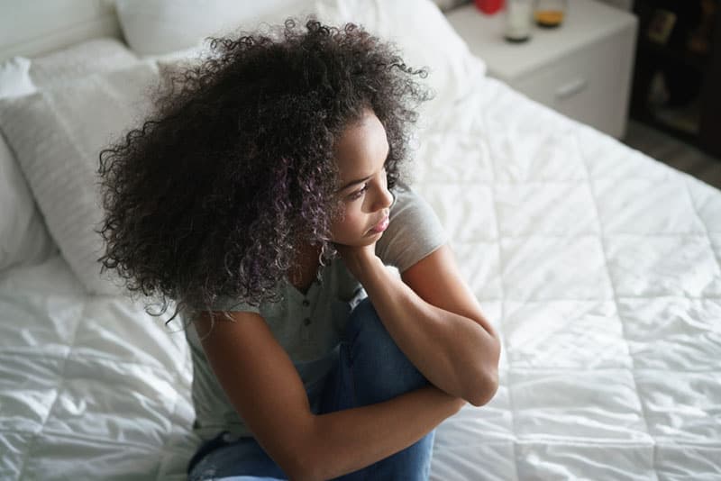 anxious woman sitting on the bed