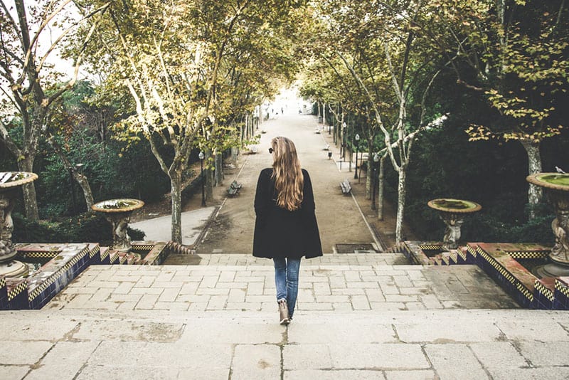 blond girl walking in old part of town