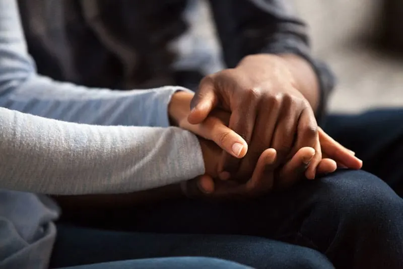 closeup photo of man and woman hands holding