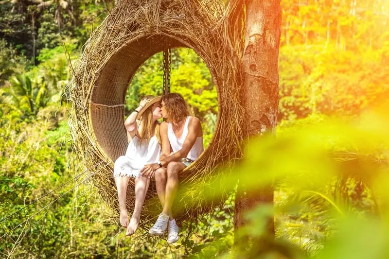 couple kissing in the woods