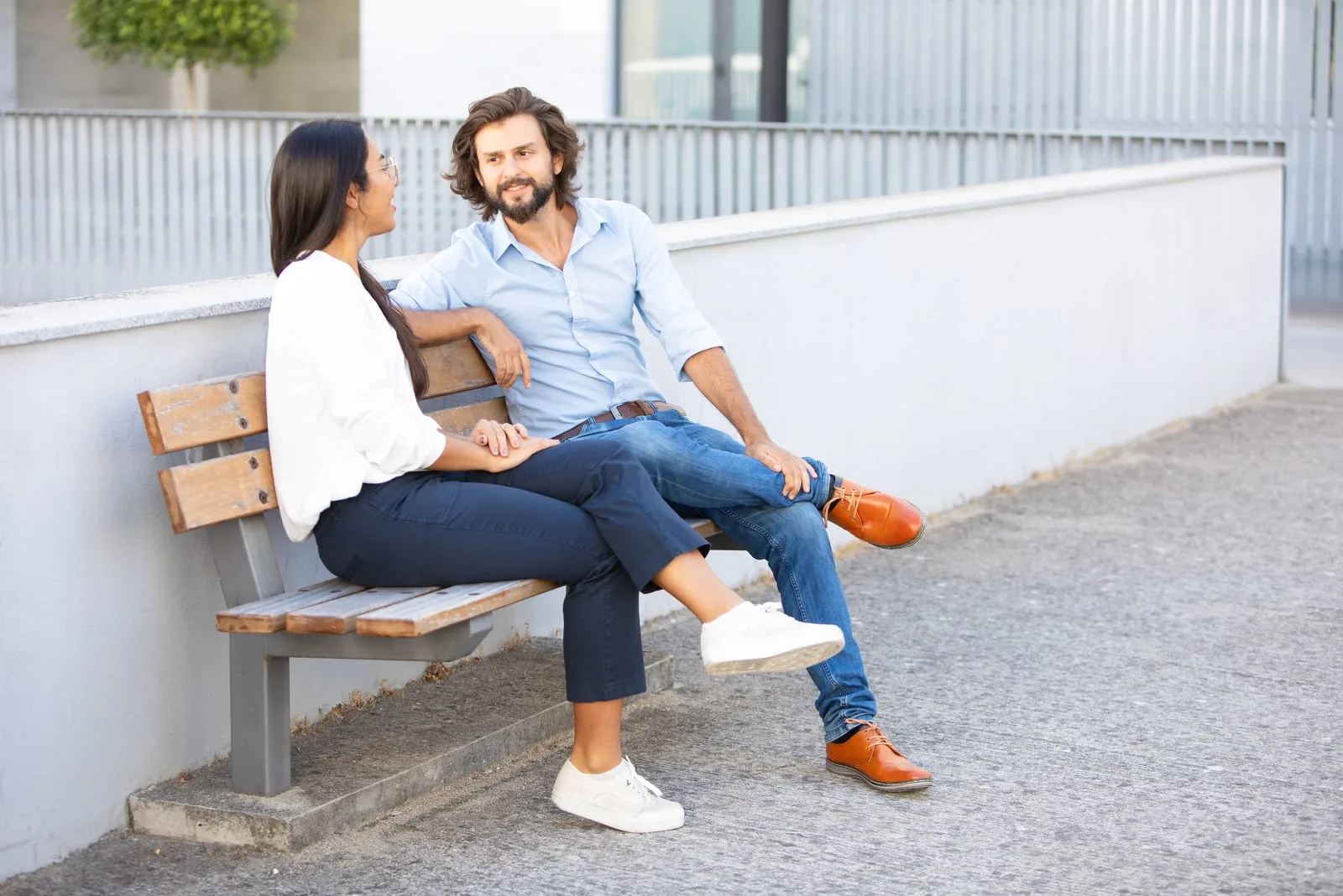 couple sitting on bench talking