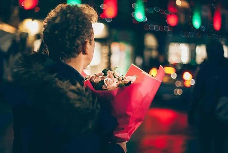 man holding a bouquet of roses