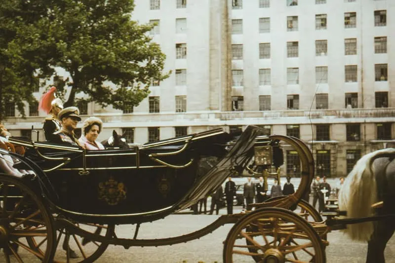 queen and the king driving in carriage