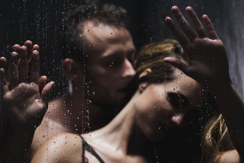 sexy man kissing a woman in the shower