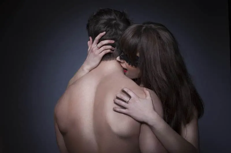 woman biting man on neck